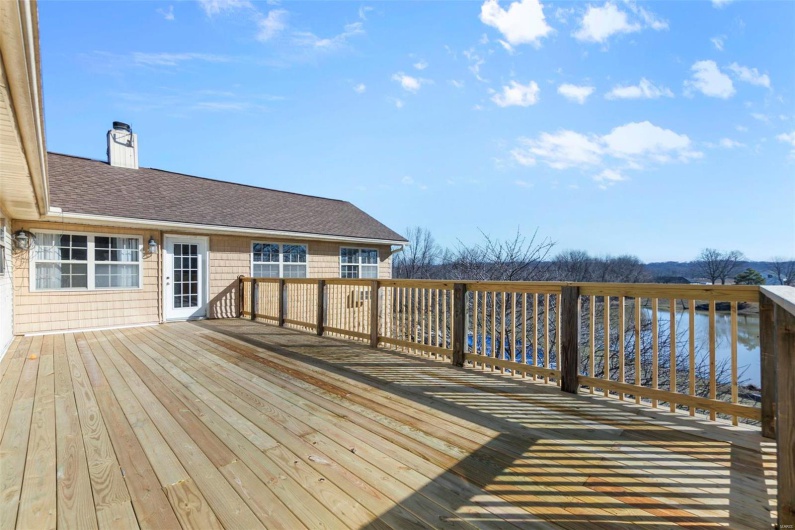 Wooden terrace featuring a water view