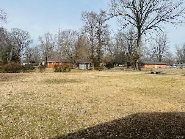 View of yard with a rural view