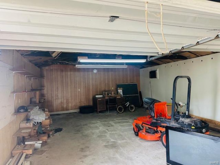 Garage featuring wooden walls