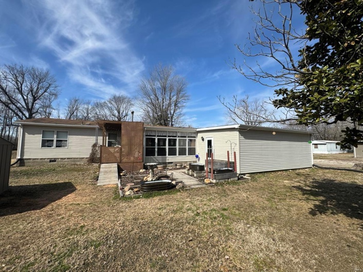 Rear view of house with a yard
