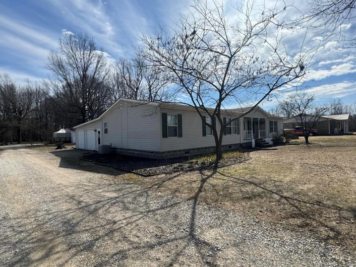 View of front of property with a garage, driveway, crawl space, and central air condition unit