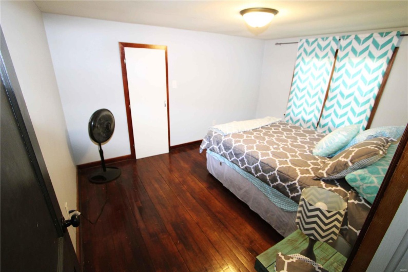 Bedroom featuring baseboards and hardwood / wood-style floors