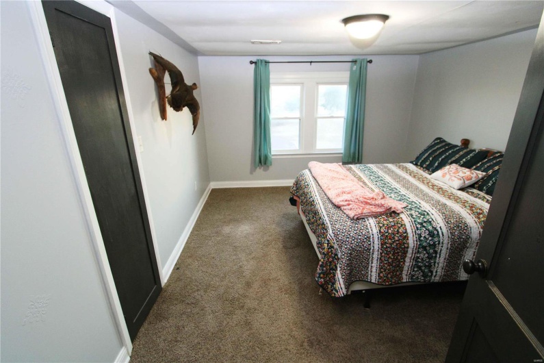 Bedroom with visible vents, baseboards, and carpet flooring
