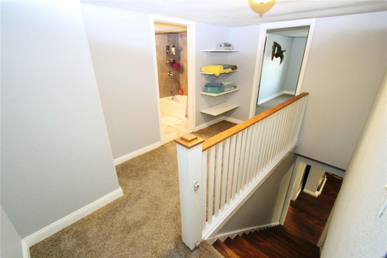 Stairs featuring carpet floors and baseboards