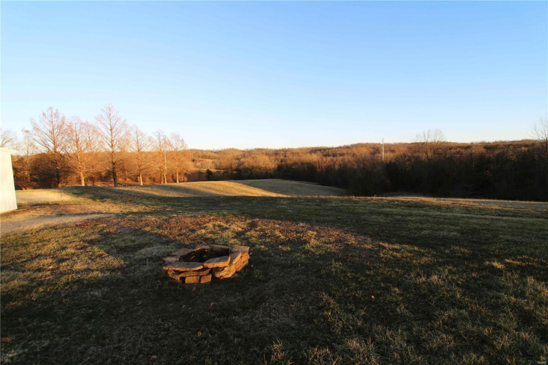 View of yard featuring an outdoor fire pit
