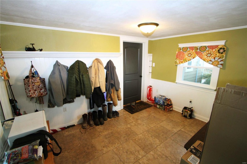 Mudroom with crown molding and baseboards