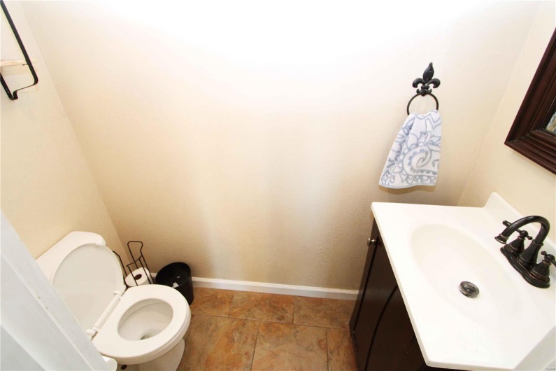 Bathroom with toilet, baseboards, and vanity