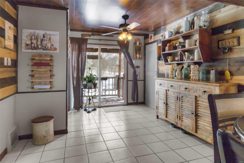 Kitchen featuring light tile patterned floors, wooden ceiling, visible vents, a ceiling fan, and open shelves