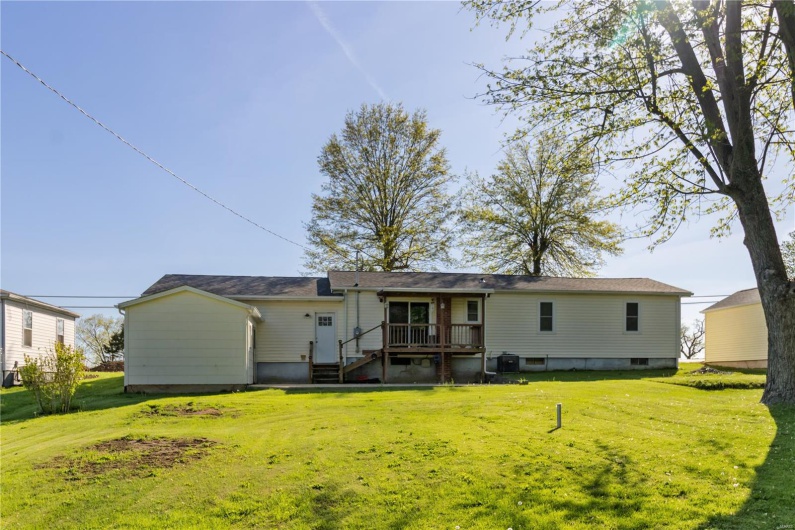 Back of property featuring a yard