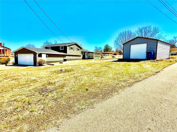 View of yard featuring an outbuilding and a detached garage