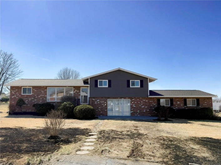Split level home with brick siding