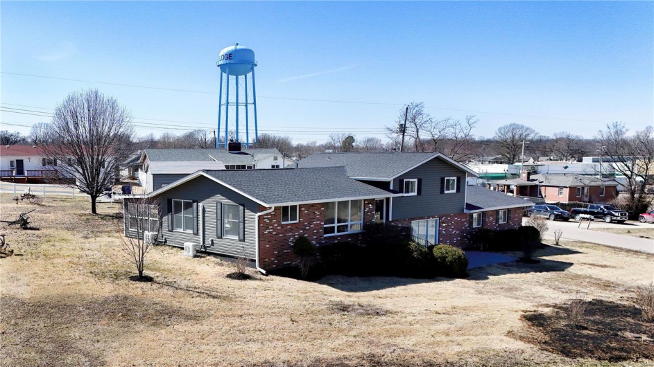 Rear view of house with brick siding and roof with shingles
