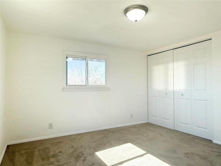 Unfurnished bedroom with carpet, a closet, and baseboards