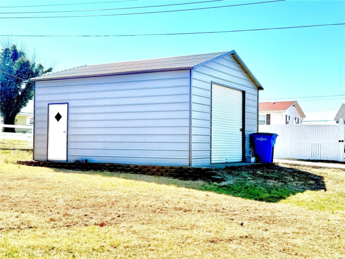 View of outbuilding with an outbuilding and fence