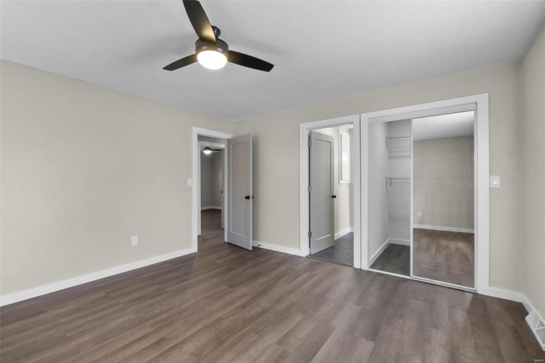 Unfurnished bedroom featuring ceiling fan, a closet, wood finished floors, and baseboards