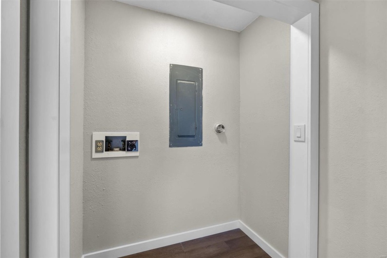 Clothes washing area featuring laundry area, washer hookup, baseboards, electric panel, and dark wood-style floors