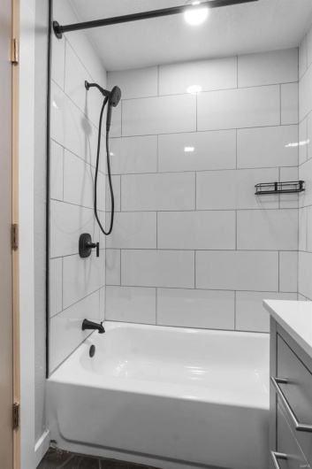 Full bathroom featuring vanity and shower / bathing tub combination