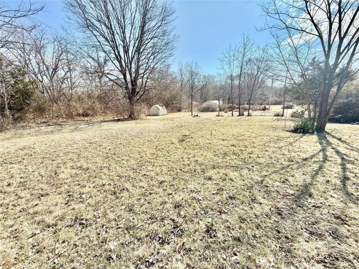 View of yard with a storage unit and an outdoor structure