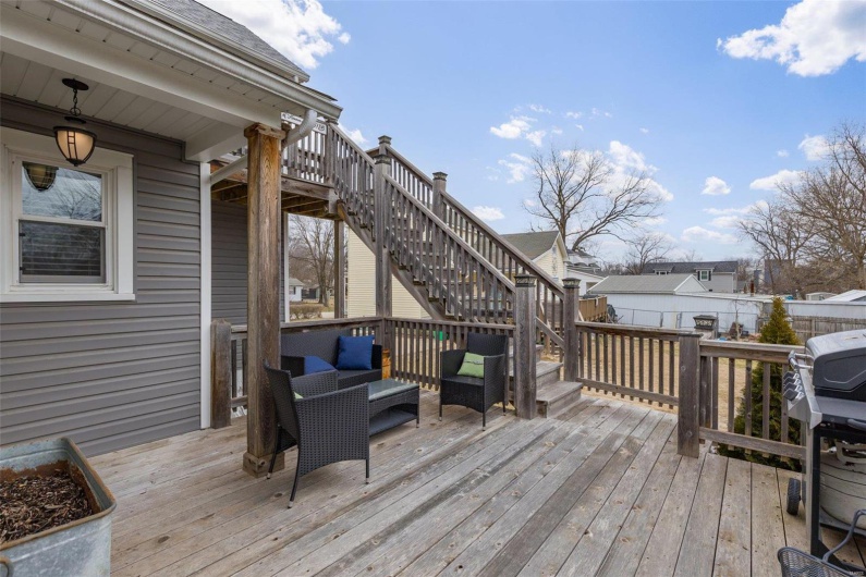 Deck featuring a grill, fence, and stairs