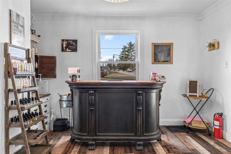 Details featuring ornamental molding, wood finished floors, a fire extinguisher, and baseboards