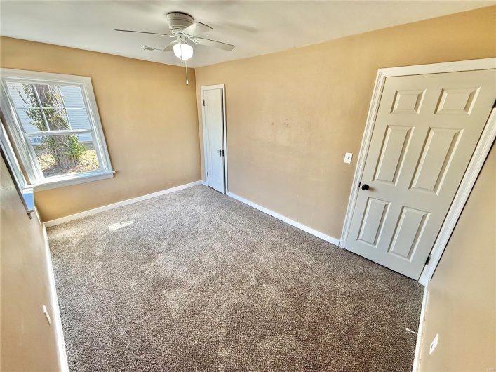Unfurnished bedroom featuring carpet flooring, a ceiling fan, and baseboards