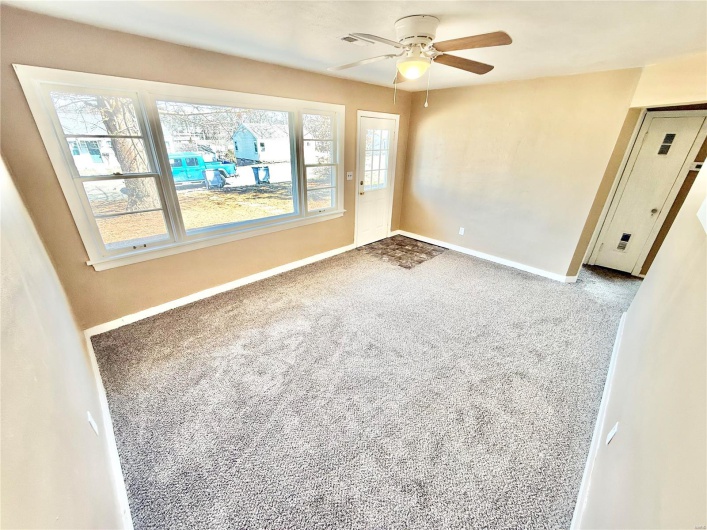 Spare room featuring ceiling fan, baseboards, and carpet flooring