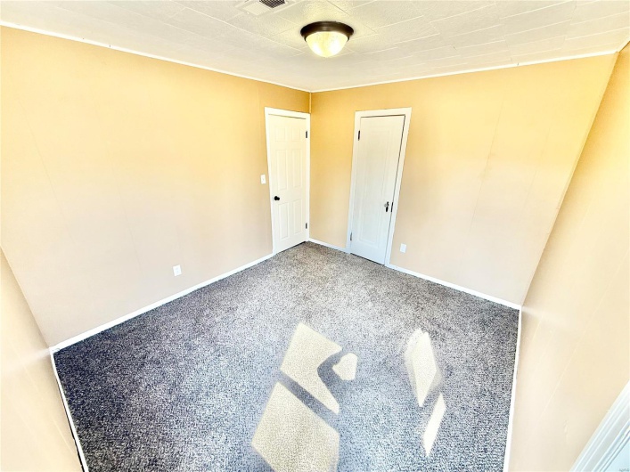 Unfurnished bedroom with baseboards and carpet flooring
