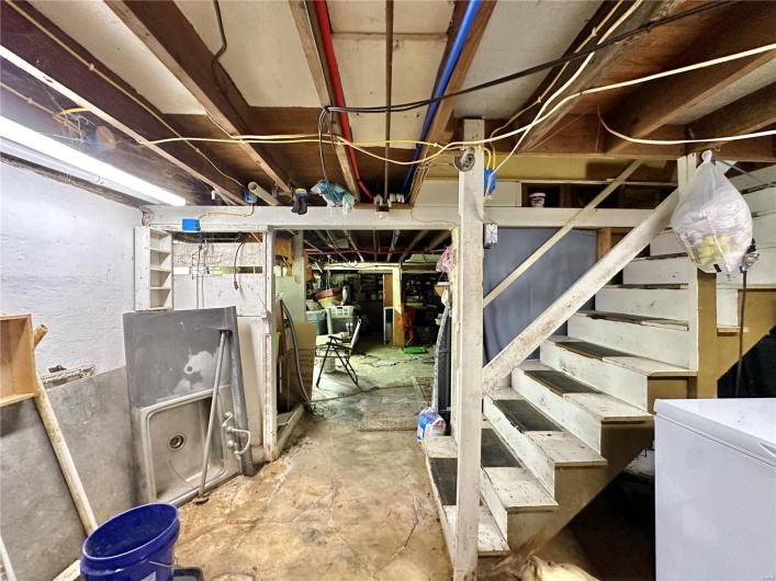 Basement featuring white refrigerator