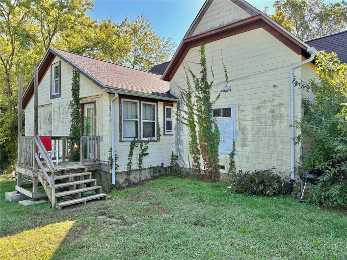 Back of property featuring a yard