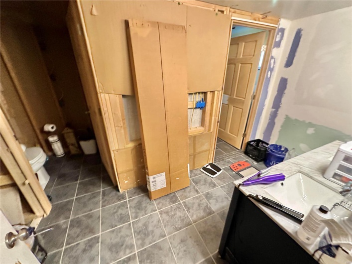 Bathroom featuring tile patterned floors, vanity, and toilet
