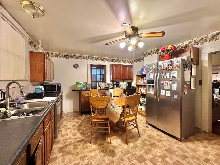 Kitchen featuring stainless steel appliances, ceiling fan, and sink
