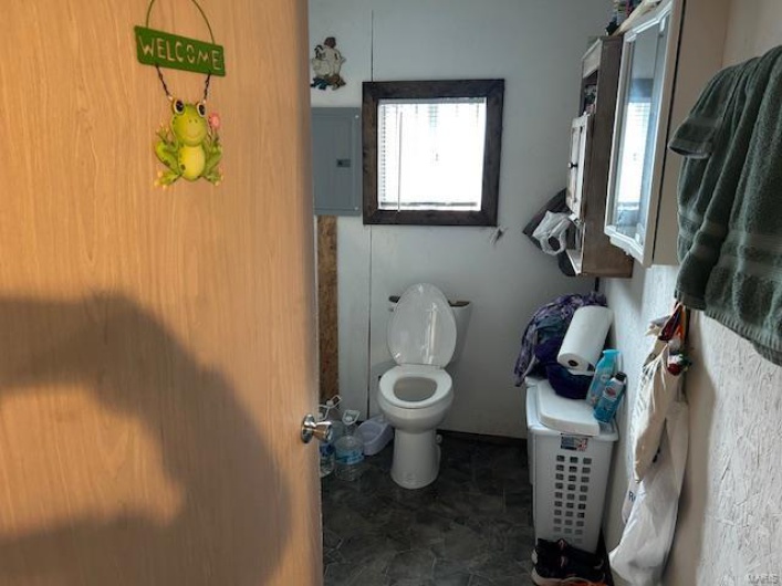 Bathroom with toilet and electric panel