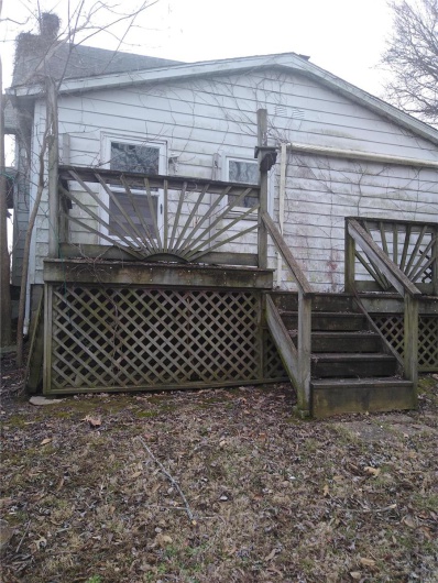 Back of house with a deck