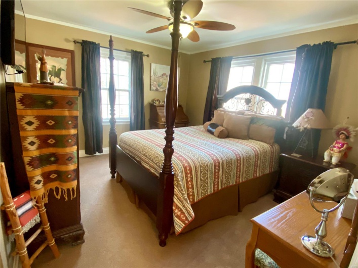 Bedroom featuring ornamental molding, carpet, and a ceiling fan