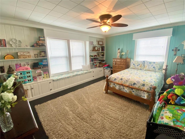 Main level bedroom with built in shelving