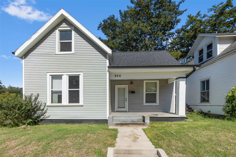 View of front of property featuring a front yard and a porch