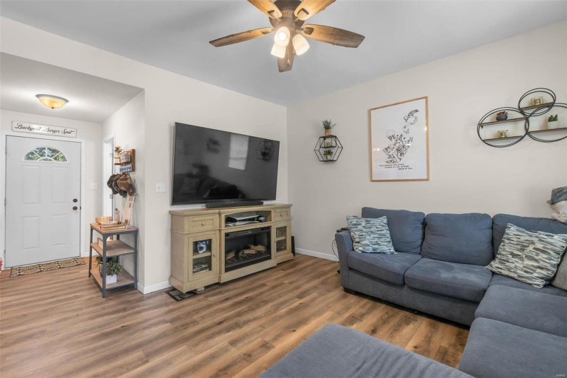 Living room with dark hardwood / wood-style floors and ceiling fan