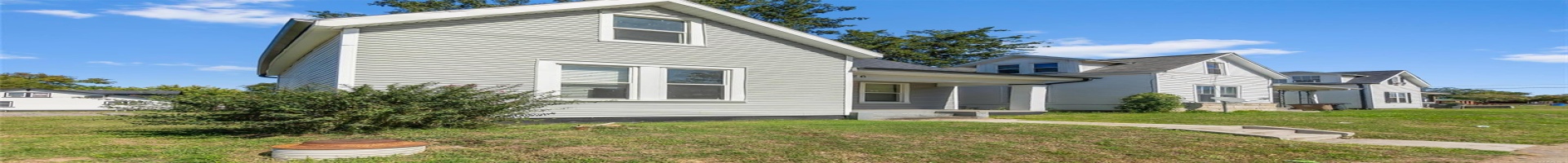 Residential For Sale View of side of home with a yard