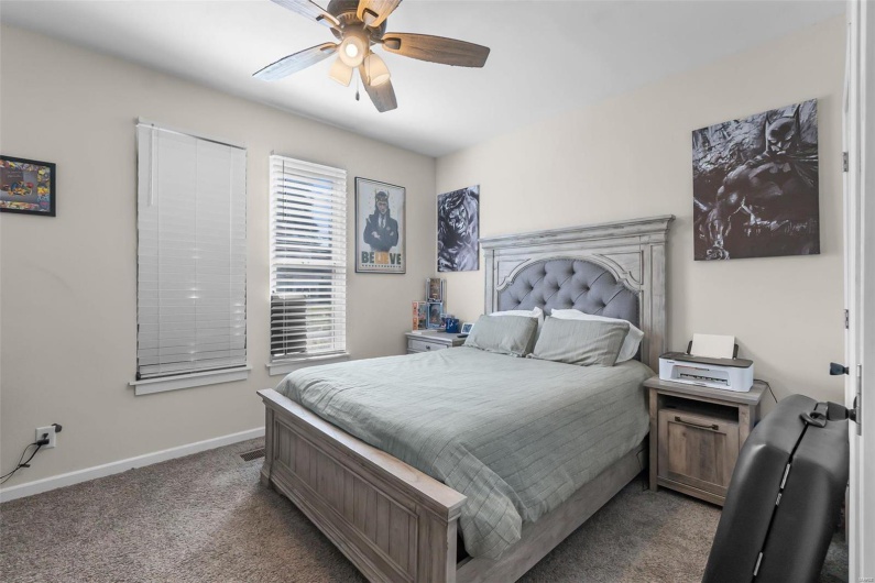 Bedroom featuring ceiling fan and carpet floors