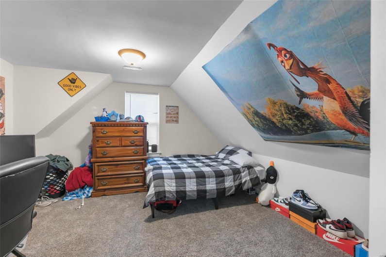 Carpeted bedroom featuring lofted ceiling