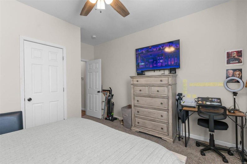 Bedroom featuring ceiling fan and carpet flooring