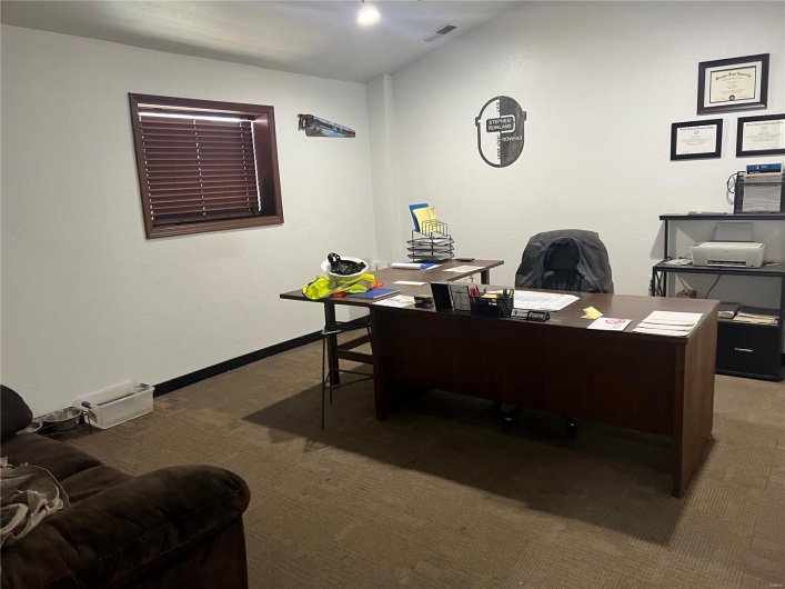 Carpeted office featuring baseboards and visible vents