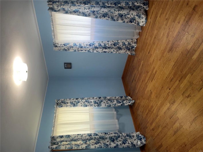 Unfurnished room featuring wood finished floors and baseboards