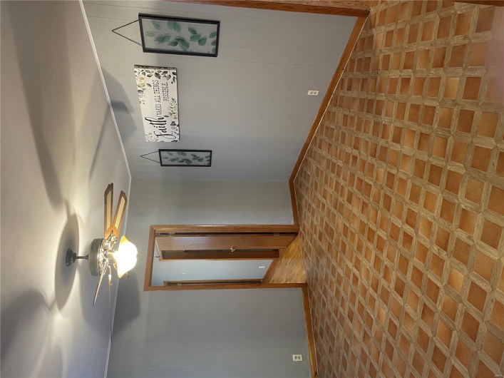 Unfurnished room with baseboards, wood walls, and a ceiling fan