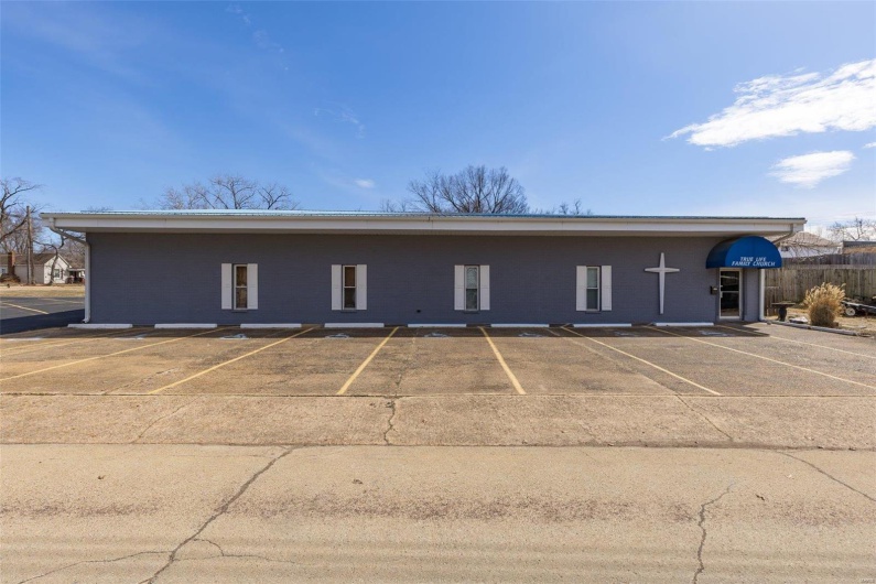 View of property with uncovered parking