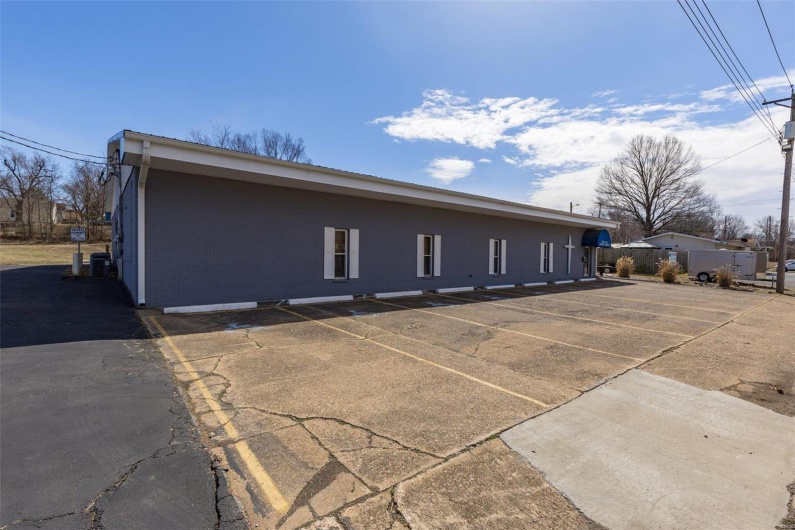 View of home's exterior featuring uncovered parking and central AC unit