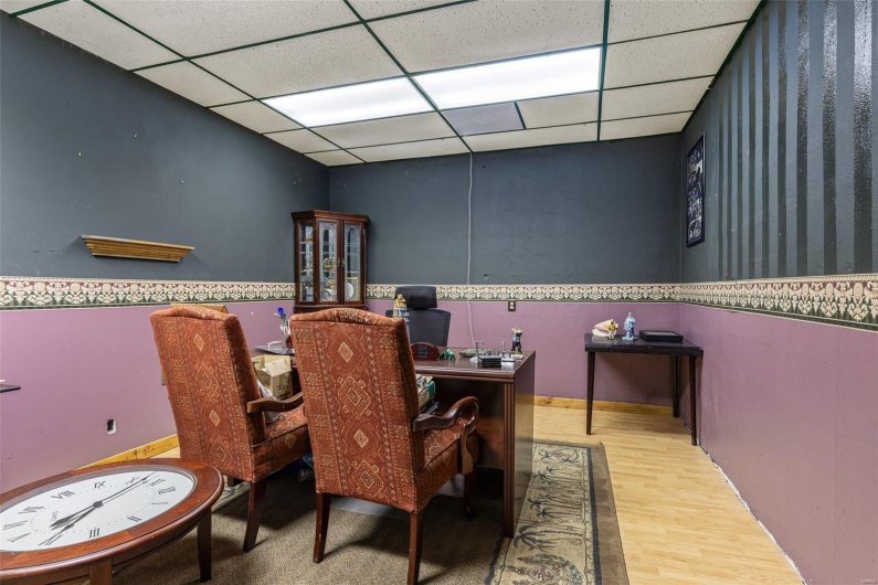 Dining area with a drop ceiling and wood finished floors