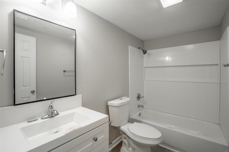 Full bathroom featuring toilet, shower / tub combination, and vanity