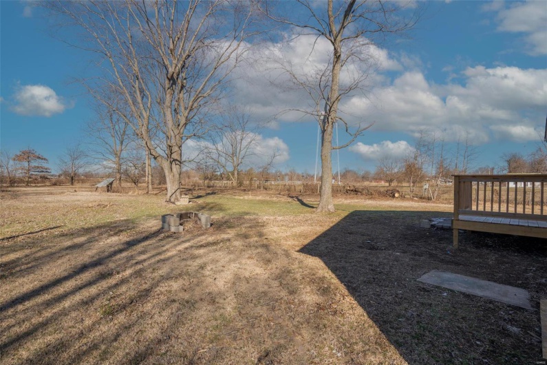 View of yard with a rural view and a wooden deck