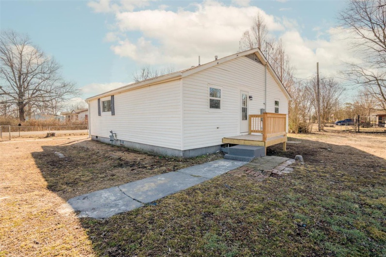 View of home's exterior featuring fence and a deck